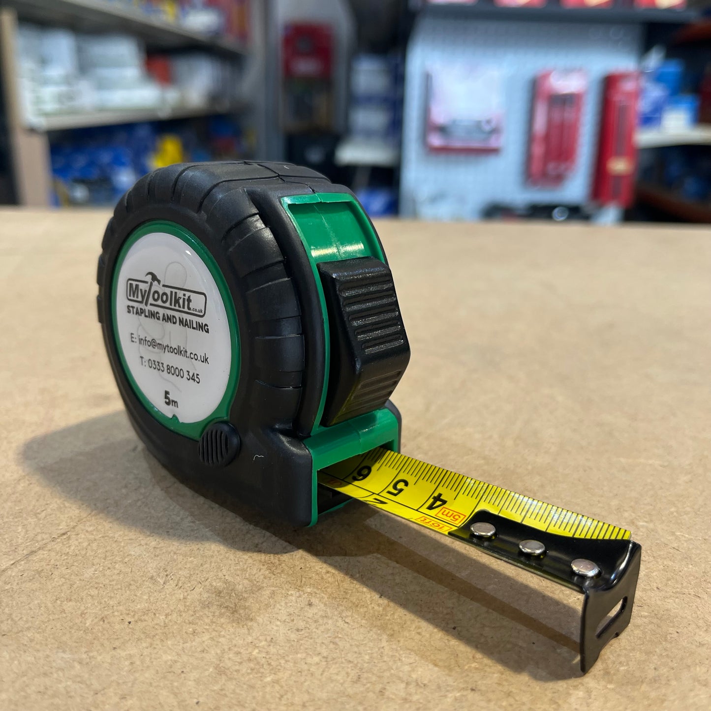 A Tape Measure with a yellow blade and rubber casing with MyToolkit Stapling and Nailing 5m on the front