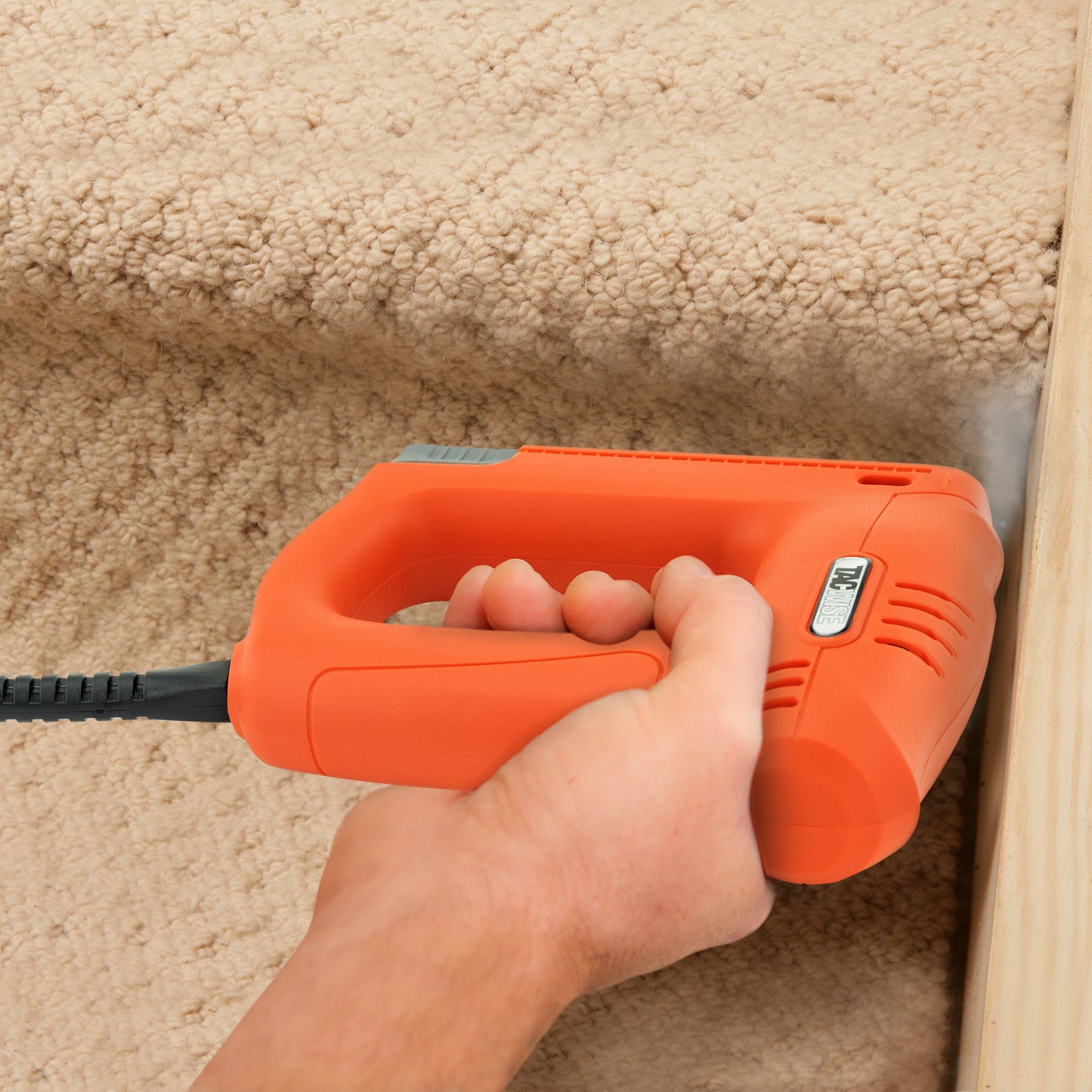 Carpet fitter using the electric Tacwise 140EL duel stapler brad nailer to fix carpet on stairs.