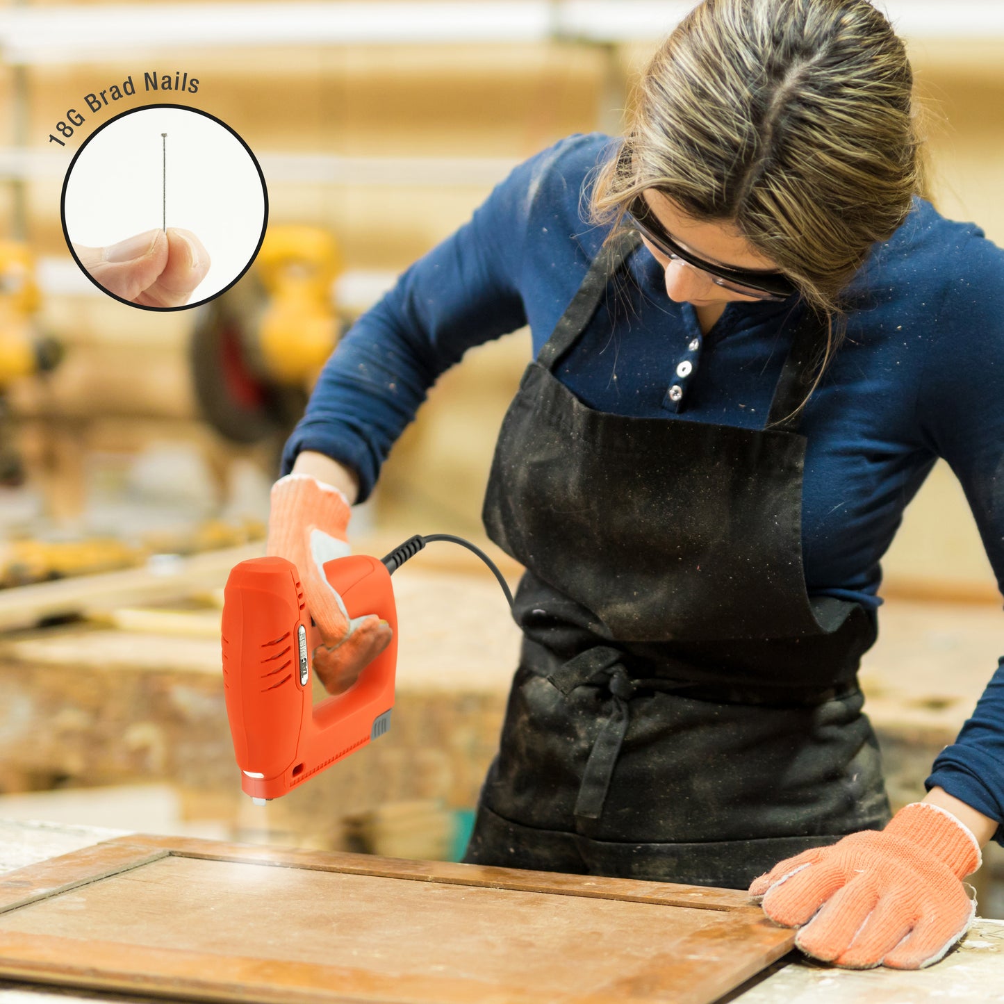 Young female carpenter using an electric Tacwise nailer to make picture frames