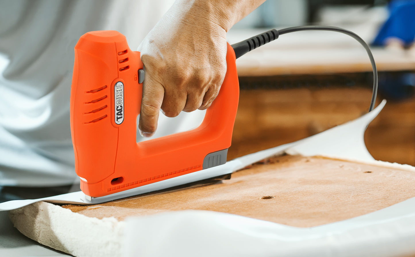 Male upholsterer using the Tacwise electric 140 series stapler to re-upholster a seat.