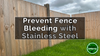 An image of feather edge fences in a garden but  the nails have caused bleeding down the fences.