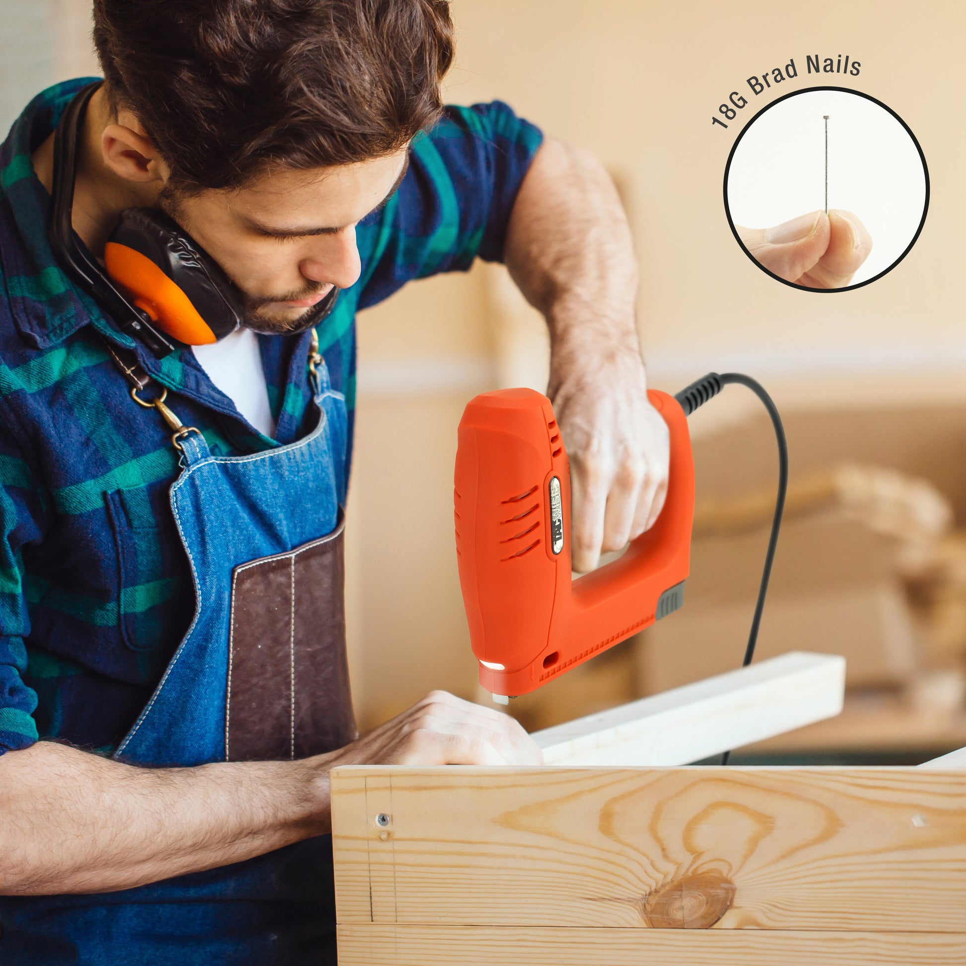 Professional male carpenter constructing timber frames in a workshop using the electric Tacwise 18 gauge brad nailer.